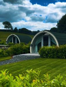 two domed buildings in a garden with a lawn at Knockmany View Glamping in Augher +36 photos