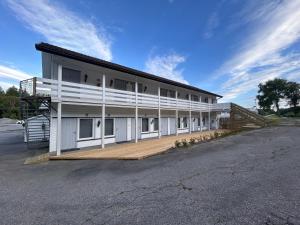 a large white building with a lot of windows at Halden Motell in Halden