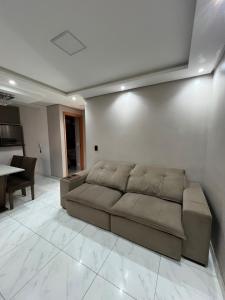 a living room with a couch and a table at 01 Conforto e estilo-piscina e garagem inclusa in São Leopoldo