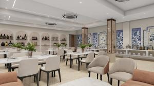 a restaurant with tables and chairs in a room at Hotel Vaarya Inn in Lucknow