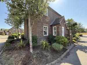 a brick house with a tree in front of it at 12 Green Close at The Bay Filey, sleeps 8, 2 dogs welcome for free too in Filey