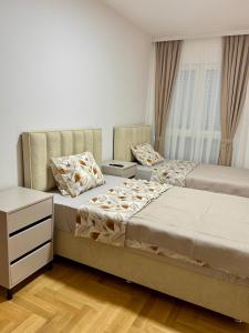 a bedroom with two beds and a window at apartment Danijela in Radanovići
