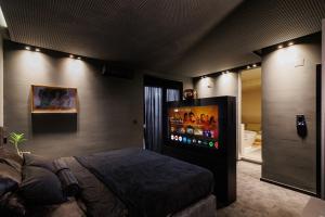 a bedroom with a flat screen tv on the wall at Hedonist SPA in Jagodina