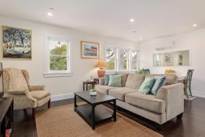 a living room with a couch and two chairs at California Comfort in Santa Barbara