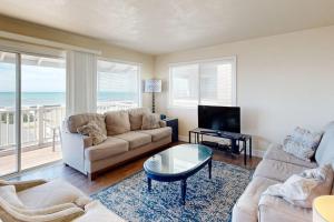 a living room with a couch and a table at Blue Door Retreat in Cayucos