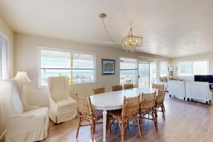 a dining room with a white table and chairs at Blue Door Retreat in Cayucos