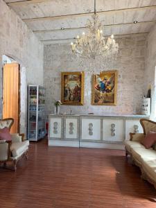 a living room with a chandelier and a couch and chairs at Chikan Hoteles in Arequipa