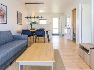 a living room with a couch and a table at Hals Apartment 100m from Beach in Hals