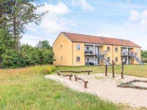 a large yellow house with a building at Hals Apartment 100m from Beach in Hals