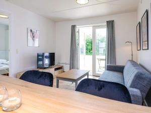 a living room with a couch and a table at Hals Apartment 100m from Beach in Hals