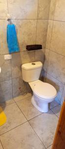 a bathroom with a toilet and a blue towel at Mirador Mindo in Mindo
