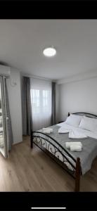 a bedroom with a large bed with white sheets and pillows at Villa Nesim in Struga