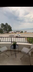 a balcony with two chairs and a table and a street at Villa Nesim in Struga