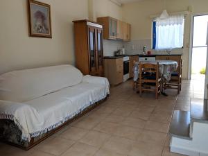 a bedroom with a bed and a table and a kitchen at Dora's Sweet Home in Mytikas