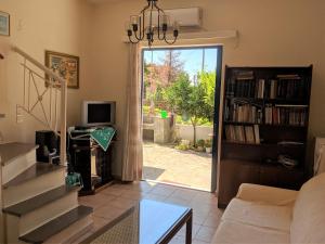 a living room with a door open to a patio at Dora's Sweet Home in Mytikas