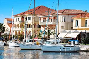 a group of boats docked in a marina with buildings at Dora's Sweet Home in Mytikas