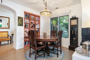a dining room with a wooden table and chairs at Garden Escape in Santa Barbara