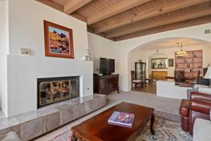 a living room with a fireplace and a couch at Garden Escape in Santa Barbara