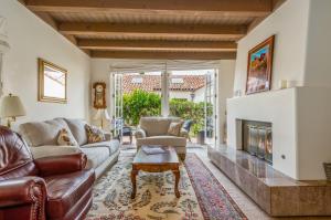 a living room with a couch and a fireplace at Garden Escape in Santa Barbara