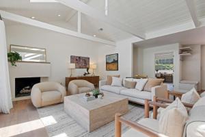 a living room with white furniture and a fireplace at Hedgerow Jewel Box in Santa Barbara