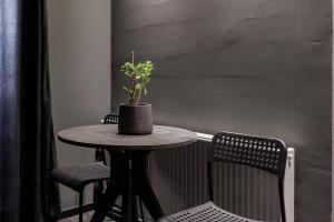 a small table with a potted plant on top of it at Hedonist SPA in Jagodina