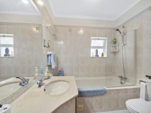 a bathroom with a sink and a tub and a shower at Casa Trajlon in Praia do Carvoeiro +13 photos