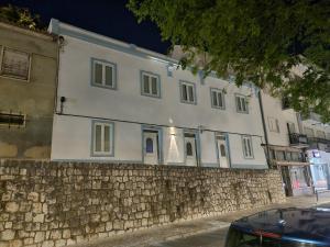 a white building with a christmas tree on top of a stone wall at Discoveries House Alenquer in Alenquer