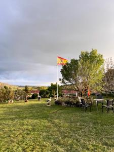 a kite flying over a field with chairs and a flag at Eclipse 2026 in Tamarón