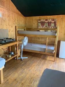 a wooden room with a desk and a bunk bed at Mountain Sanctuary Park in Rustenburg