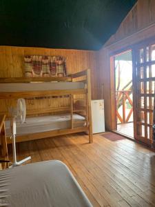 a bedroom with a bunk bed and a wooden floor at Mountain Sanctuary Park in Rustenburg