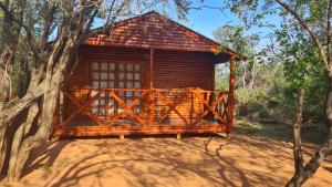 a wooden cabin in the middle of a forest at Mountain Sanctuary Park in Rustenburg