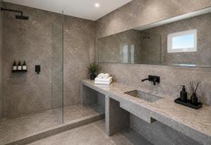 a bathroom with a sink and a glass shower at Purobaires Hotel Boutique in Buenos Aires +53 photos