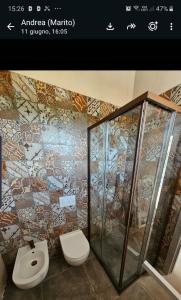 a bathroom with a toilet and a shower at Villa Altea Boutique Hotel in Terranuova Bracciolini