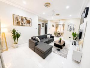 a living room with a couch and a table at Naso Luxe Homes in Sakumona