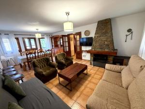 a living room with a couch and a fireplace at Cases Artigues in Os de Civís
