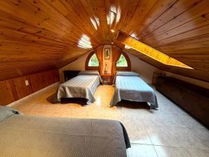 a attic room with two beds and a large window at Cases Artigues in Os de Civís