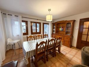 a dining room with a table and chairs at Cases Artigues in Os de Civís