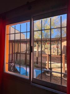 a window with a view of a pool seen through it at Casitas Del Champaqui in Villa Yacanto