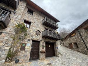 a large stone building with two balconies on it at Cases Artigues in Os de Civís