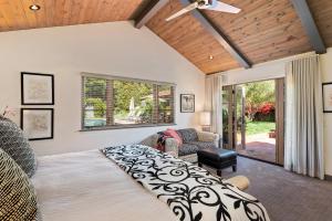 a bedroom with a bed and a ceiling fan at Casa Alegria in Santa Barbara