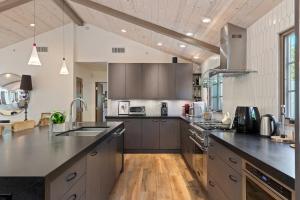 a large kitchen with stainless steel appliances and wooden floors at Casa Alegria in Santa Barbara +31 photos