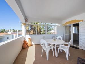 a dining room with a table and chairs on a balcony at Casa Trajlon in Praia do Carvoeiro