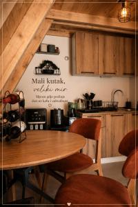 a kitchen with a wooden table and chairs at Vikendica AS22 in Žabljak