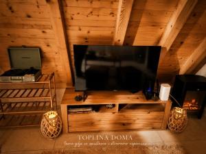 a large flat screen tv on a wooden wall at Vikendica AS22 in Žabljak