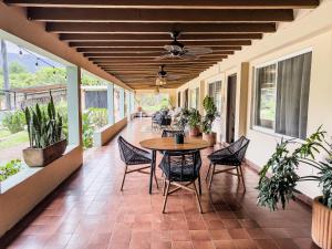 a porch with a table and chairs on it at Refugio del Colibrí in Tepoztlán