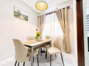 a dining room with a table and chairs at Naso Luxe Homes in Sakumona