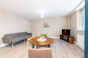 a living room with a couch and a table at 1 bed flat in Wolverhampton city centre in Wolverhampton