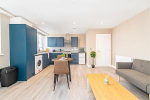 a kitchen and living room with a couch and a table at 1 bed flat in Wolverhampton city centre in Wolverhampton