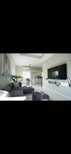 a living room with a couch and a tv at Teika comfort in Kingston