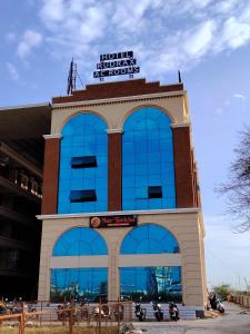 a building with motorcycles parked in front of it at Hotel Rudrax in Waghoria